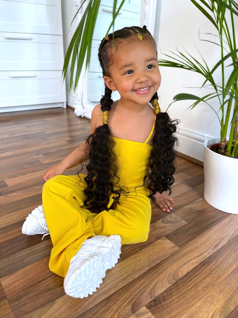 Lynnie is wearing Mini Werk It Out Sneakers (White) and Mini It's Mood Tube Jumpsuit from NovaKids.